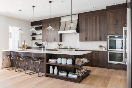 Modern Kitchen with central island and dark cabinets.